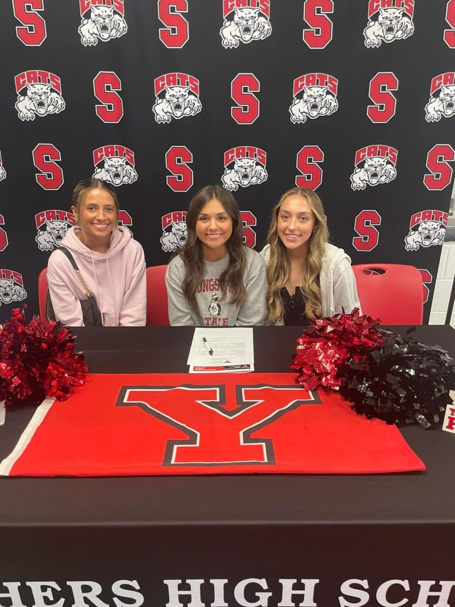 Laci Ekoniak (middle) is continuring her cheerleading career at Youngstown State University.